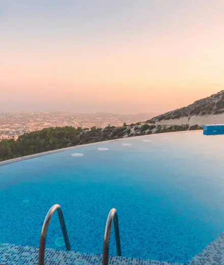 Swimming pool at a home on a hillside with a view